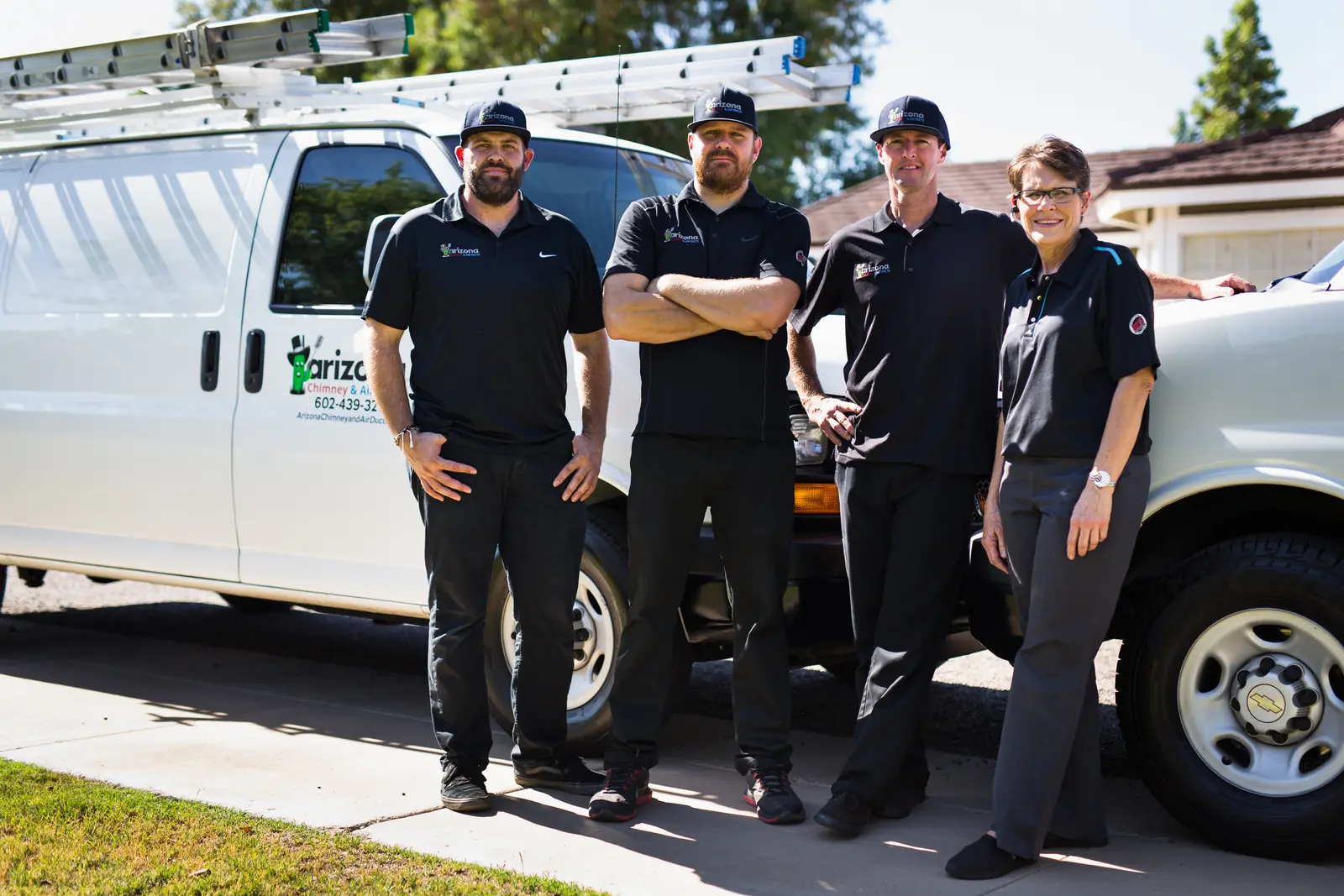 Arizona Chimney & Air Ducts technicians and owner standing in front of a company van