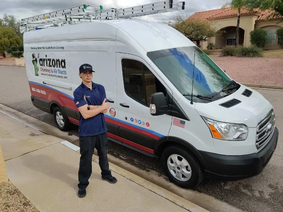 Technician standing beside an Arizona Chimney & Air Ducts van